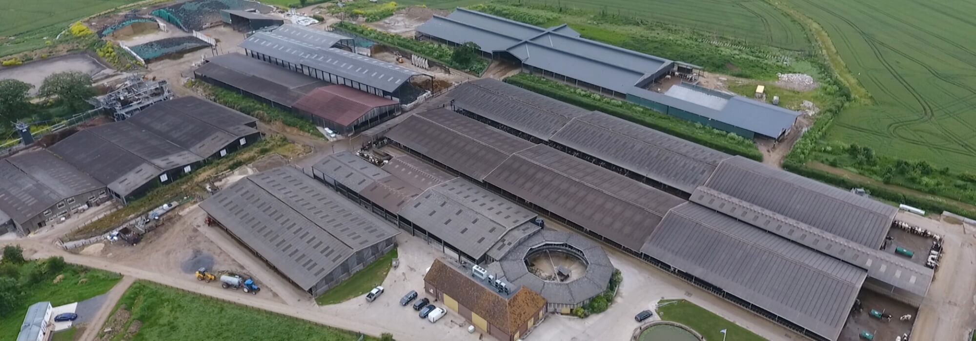Very large factory farm surrounded by fields.