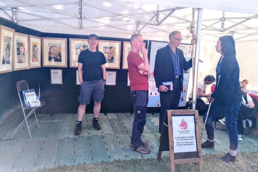 Niall, Stephen and Stef on our stall at Greenbelt with the Dreams and Realities paintings