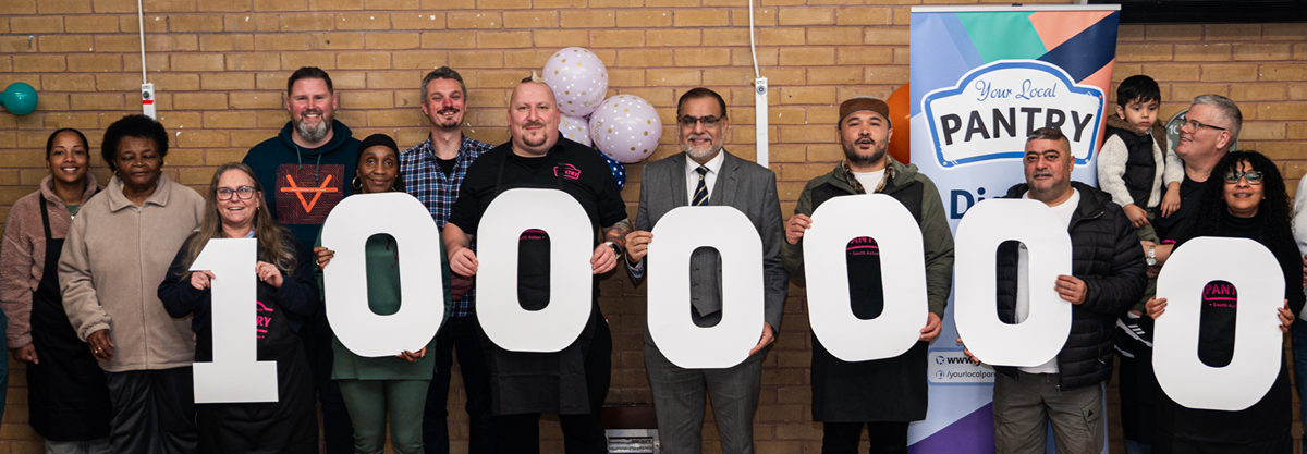 A line of people hold white numbers in the shape of 1,000,000