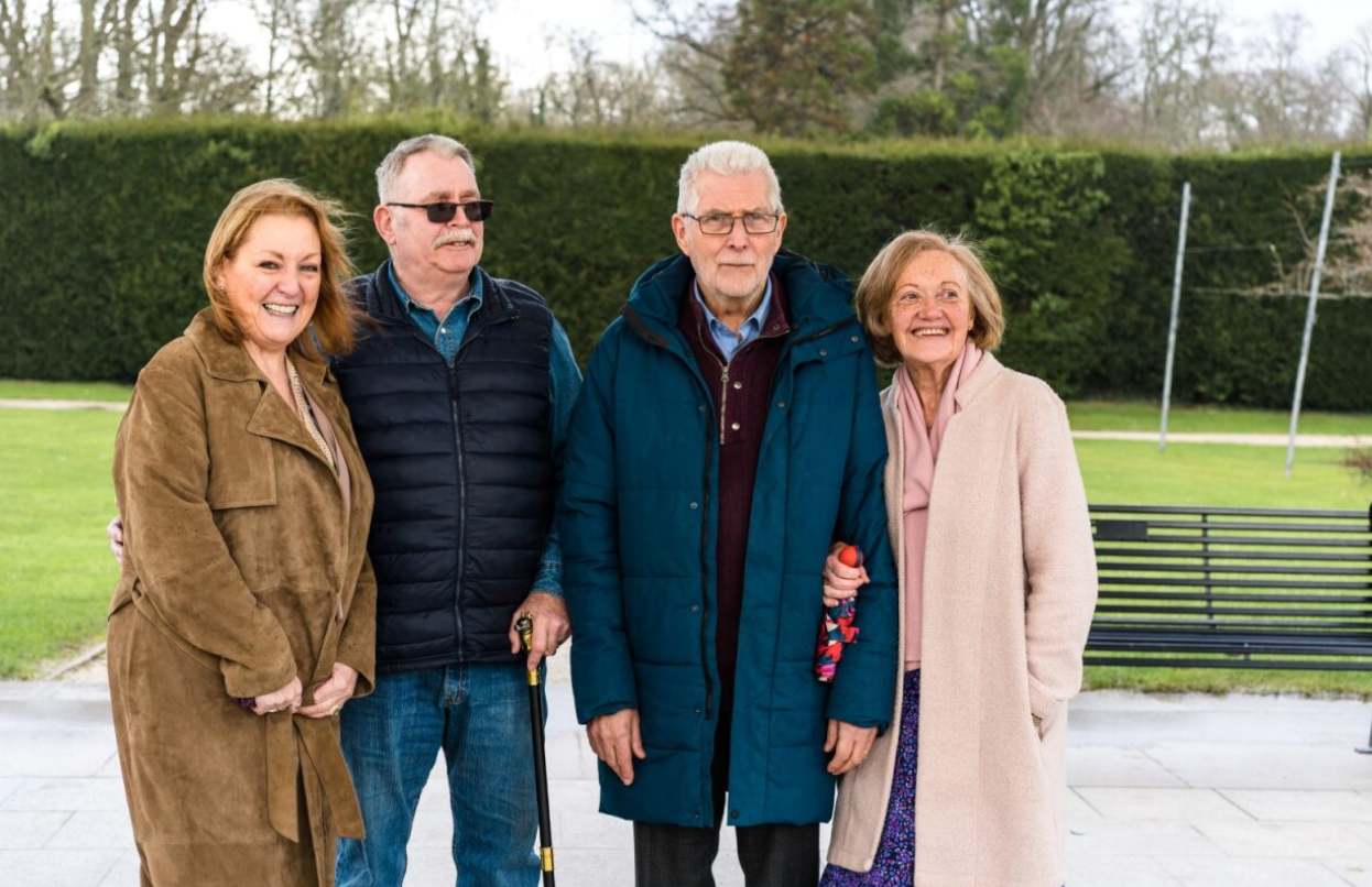 Group of people stood outside smiling