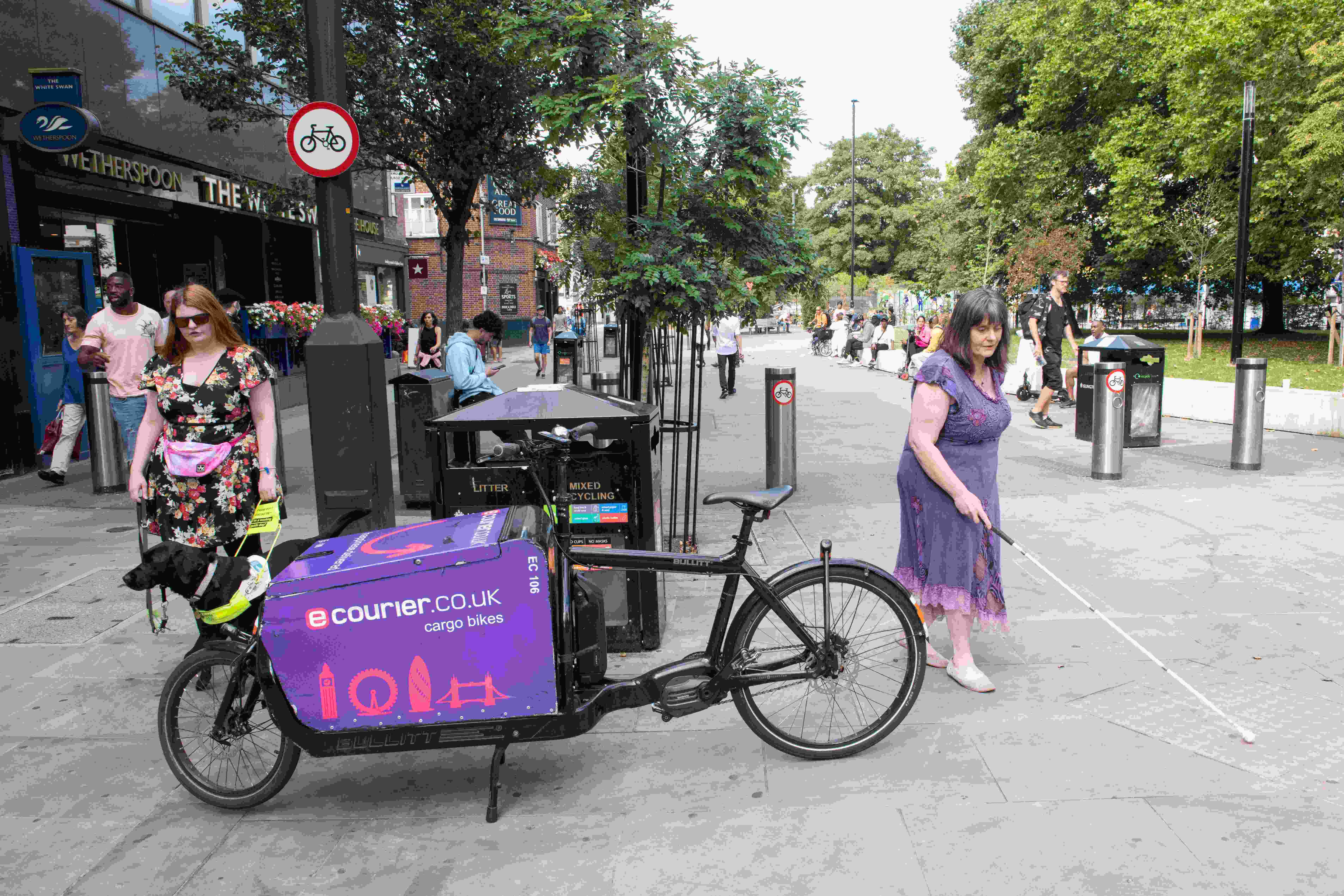 Bernie and Abby are forced to walk on either side of a big cargo bike which has been parked on the pavement.
