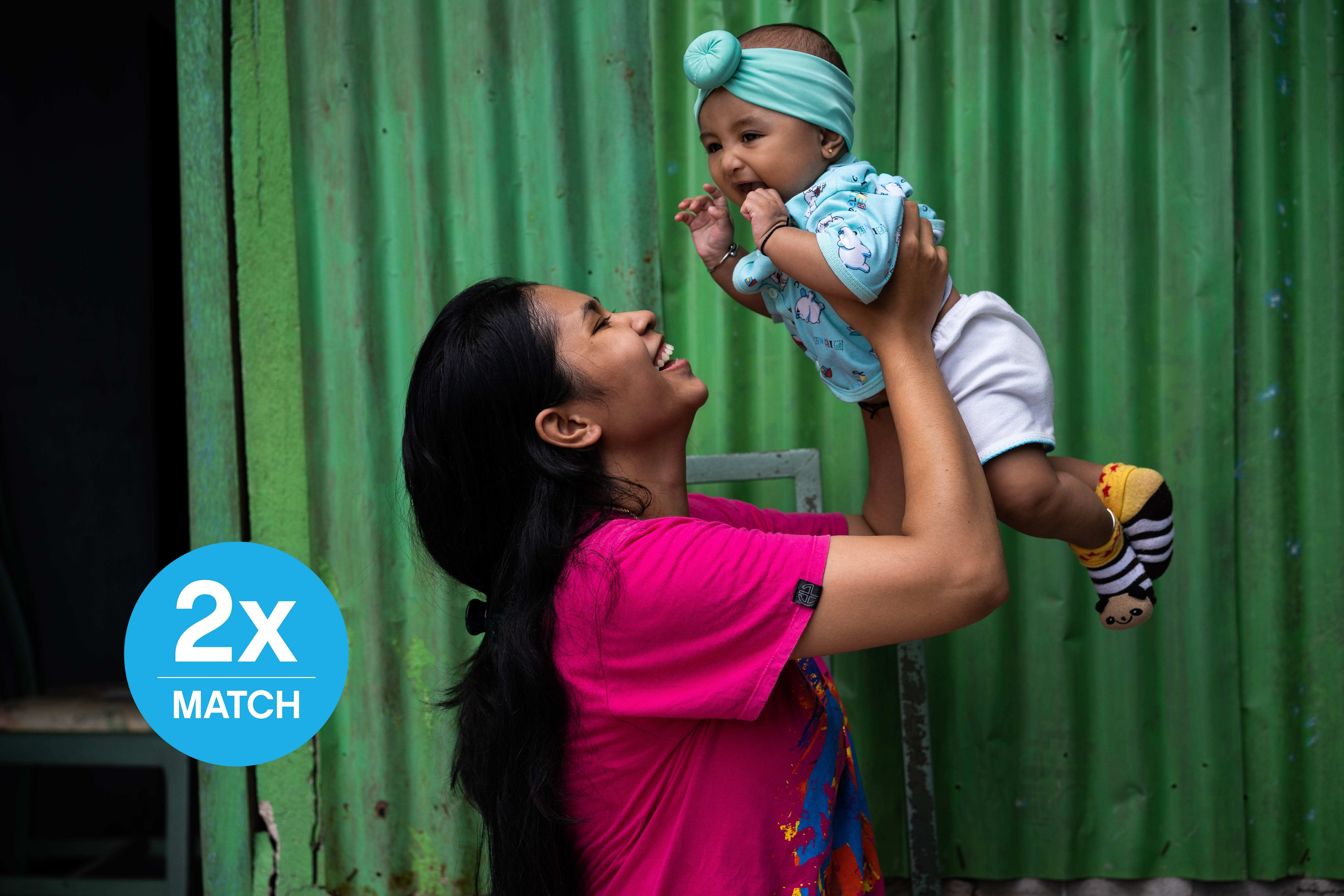 Enciana celebrates after her daughter Fayra received her polio vaccine at a UNICEF-supported health centre in Indonesia.