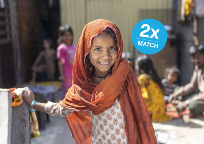 7-year-old girl smiles at the camera in Jaipur, India.