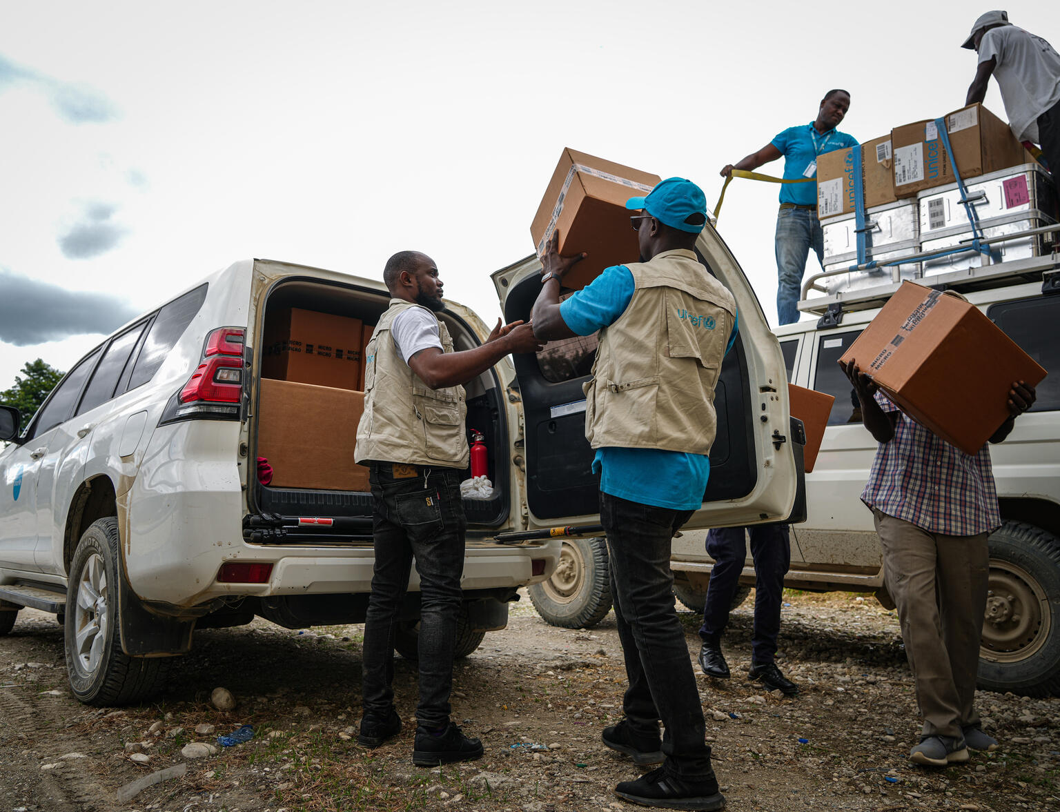 UNICEF staff loads boxes of medical kits to a UNICEF vehicle in Haiti