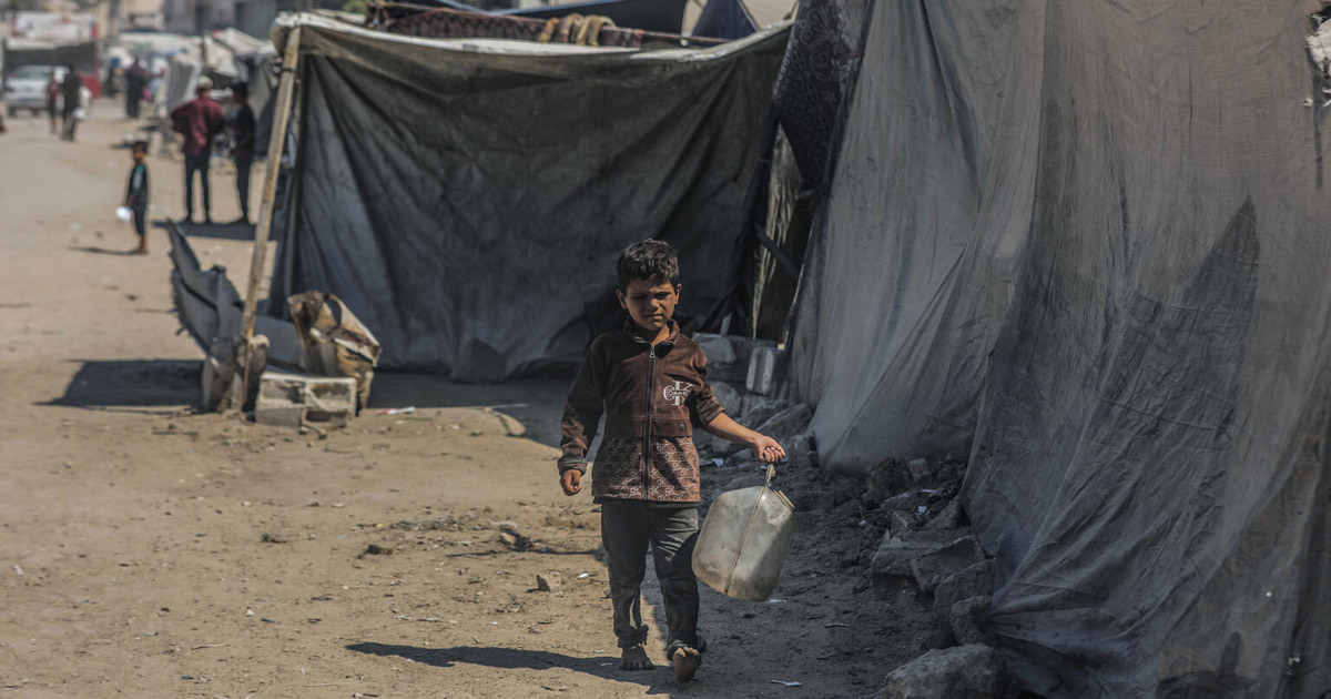 A boy carries a jerrycan of water in Gaza.