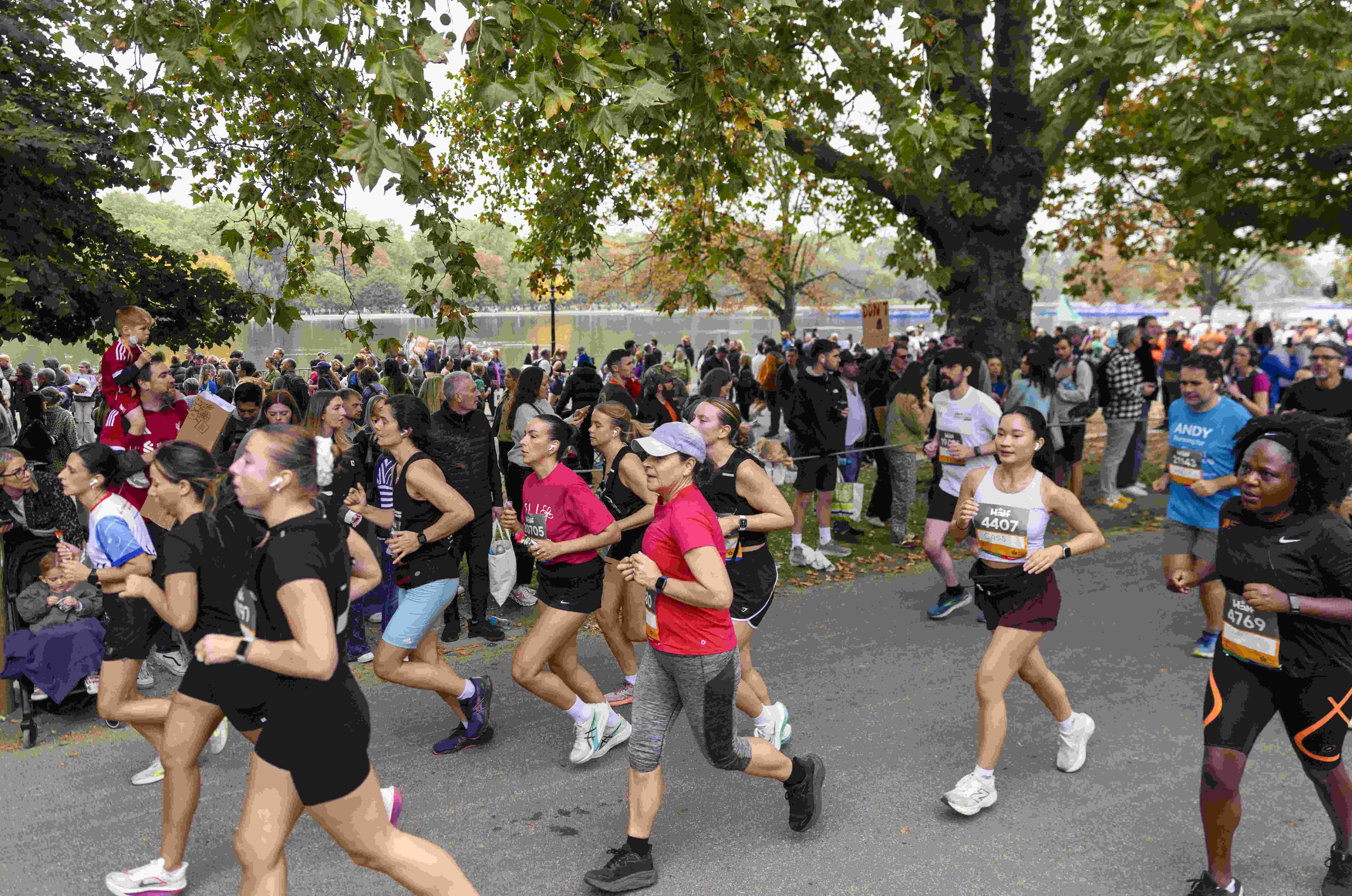 A group of runners at the Royal Parks half marathon being watched by a crowd