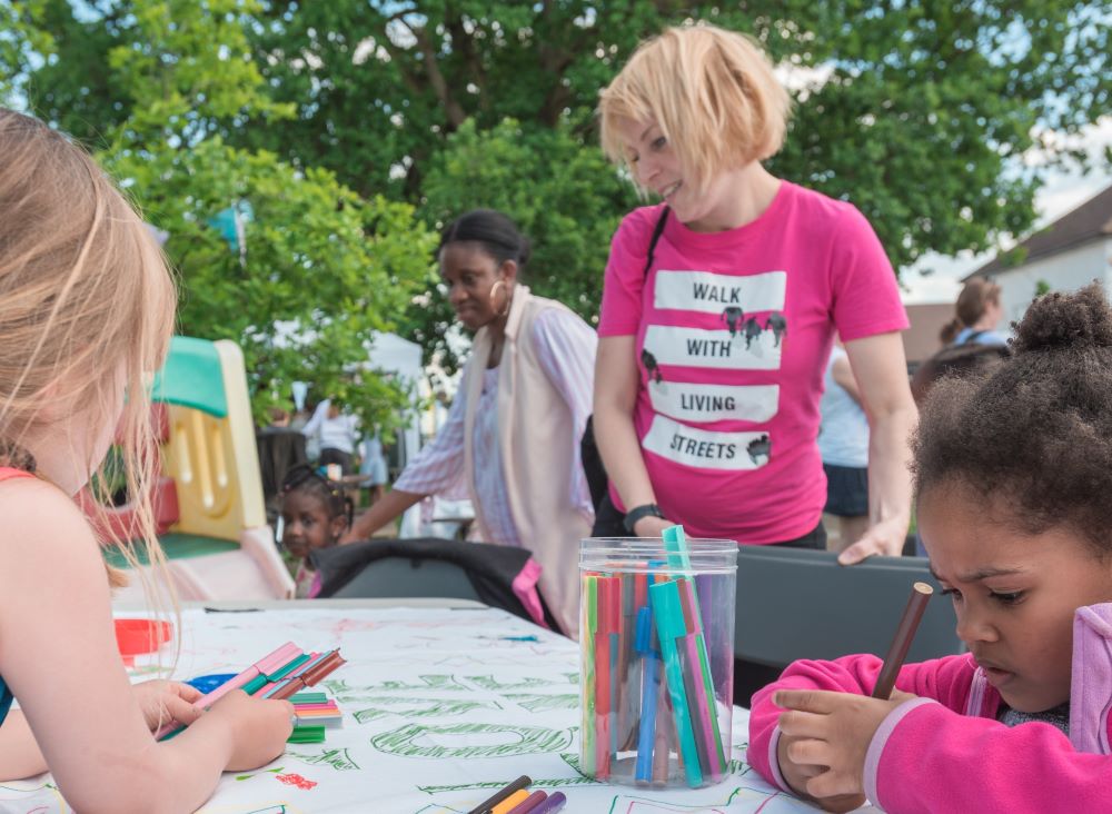 People at an event drawing at the table