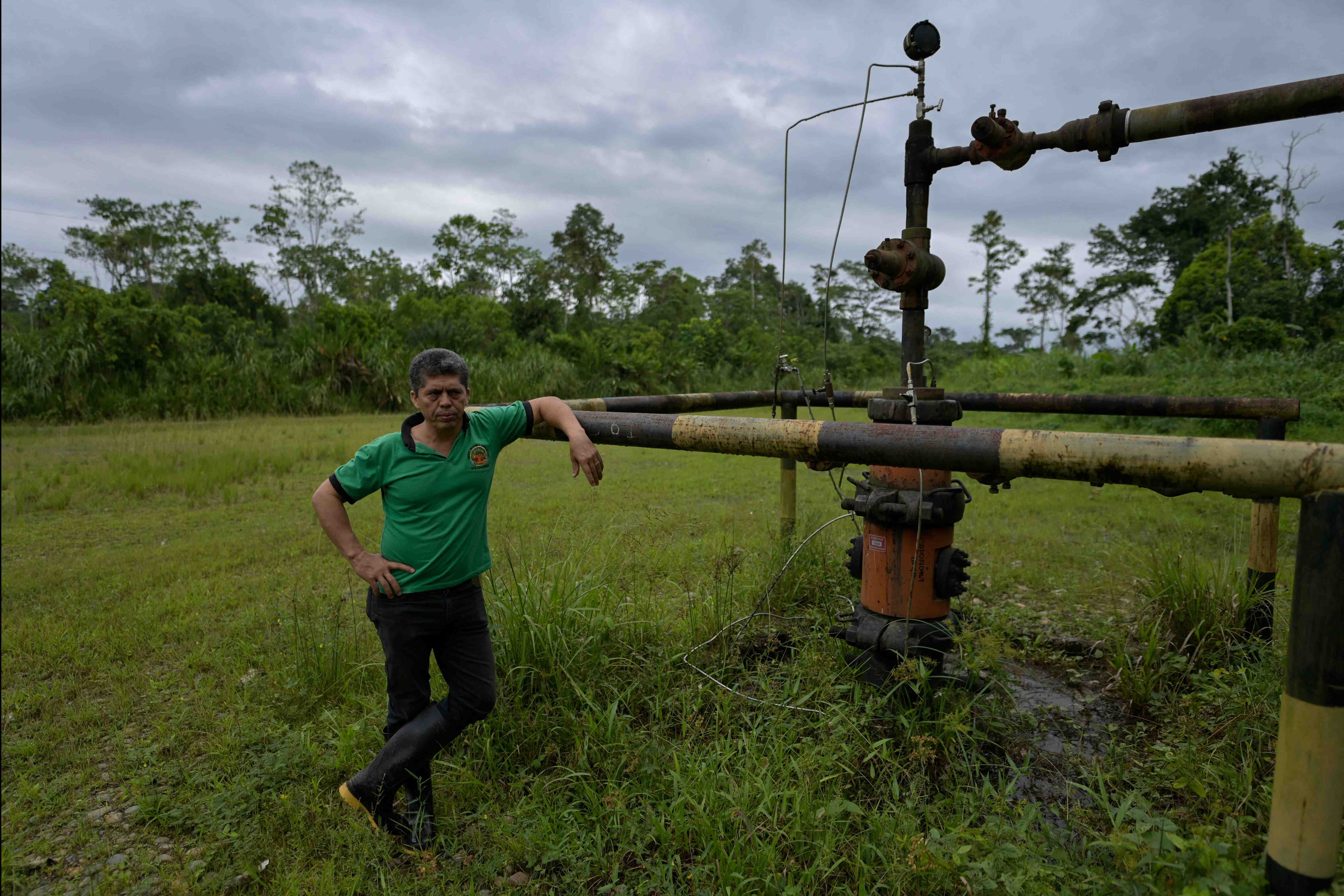 Ecuadorian lawyer and activist Pablo Fajardo Mendoza, member of the Union of People Affected by Texaco (UDAPT), stands next to an oil well, during a tour to the areas affected by the Chevron/Texaco oil company, in Shushufindi, in the Sucumbíos Province, Ecuador, on January 7, 2023.