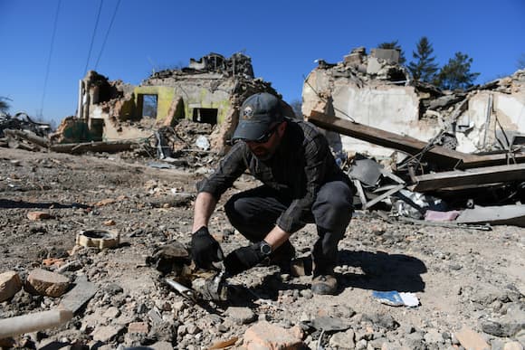 Brian Castner examines rubble of destroyed building in Ukraine