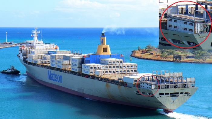 Large ship with a close-up of a shipping container on board holding cattle.