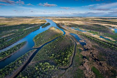 Areal view of the River Delta in Saskatchewan under a blue sky.