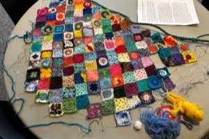 A tapestry of crocheted squares woven into a salvaged gill net that once entangled an orca on the East Coast.