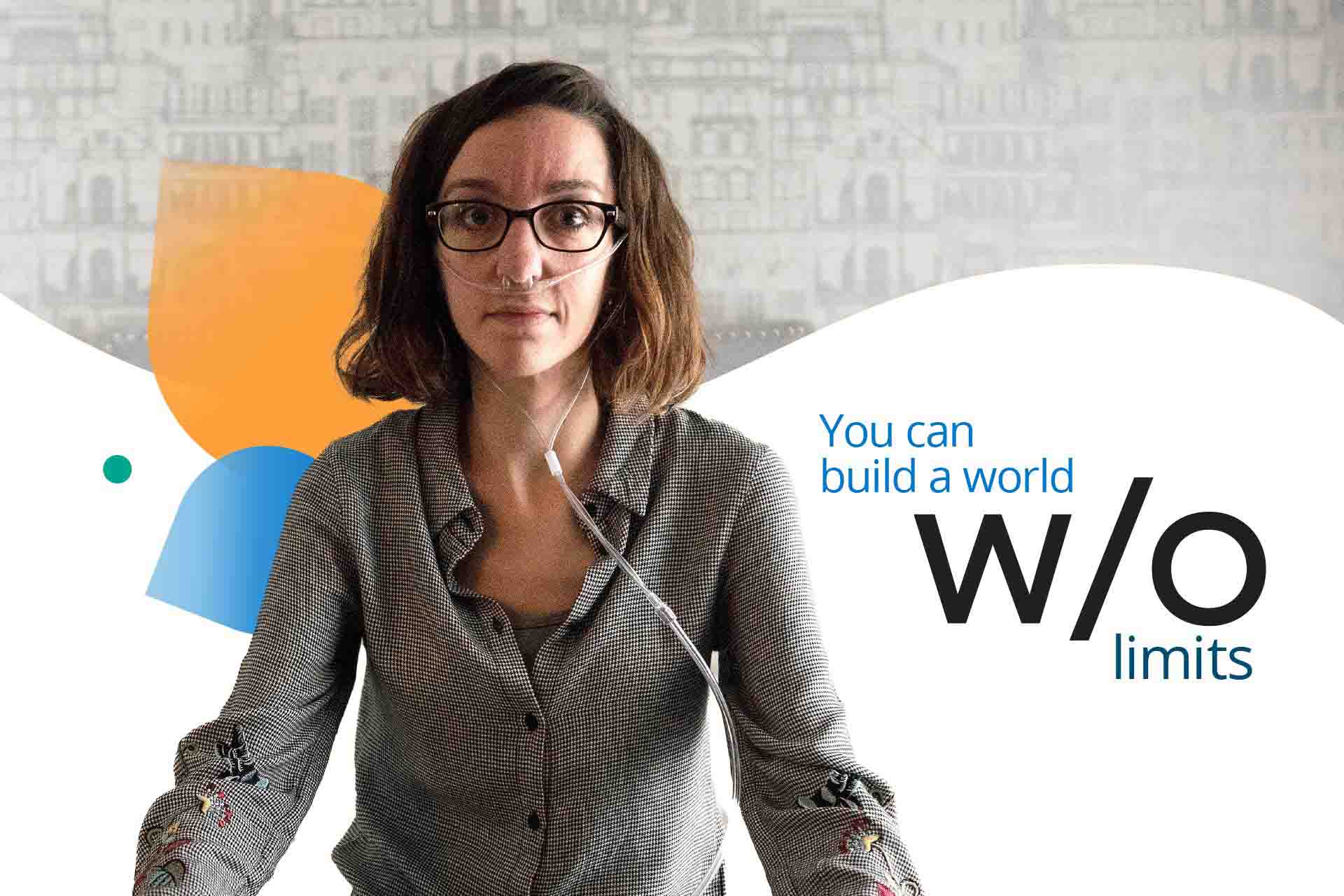 A young woman with oxygen support tubes, sitting on her bed, staring at the camera.