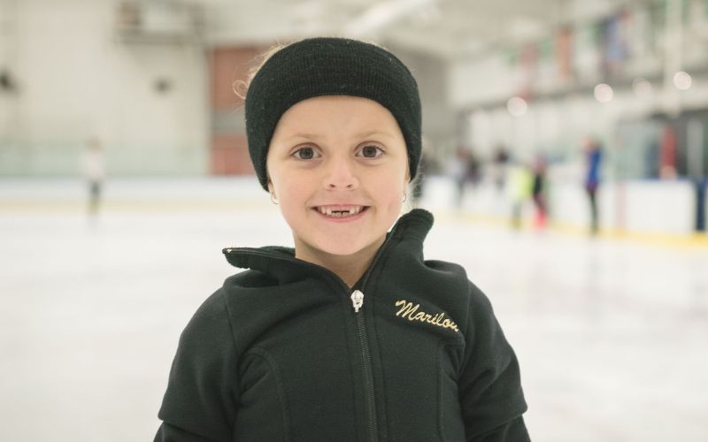 smiling child on a skating rink
