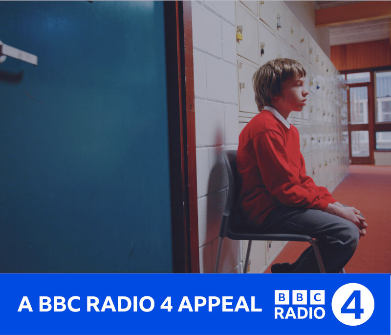 A schoolboy sat alone outside a classroom. Underneath is a banner reading "A BBC Radio 4 Appeal"