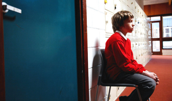 Boy sitting in corridor