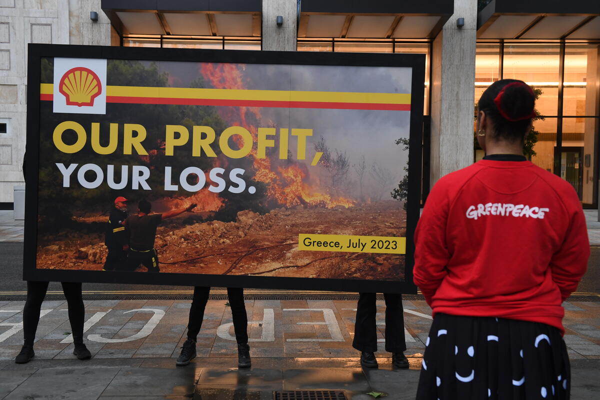 Demonstranten richten een gigantisch billboard op bij het hoofdkantoor van Shell in Londen met de slogan 