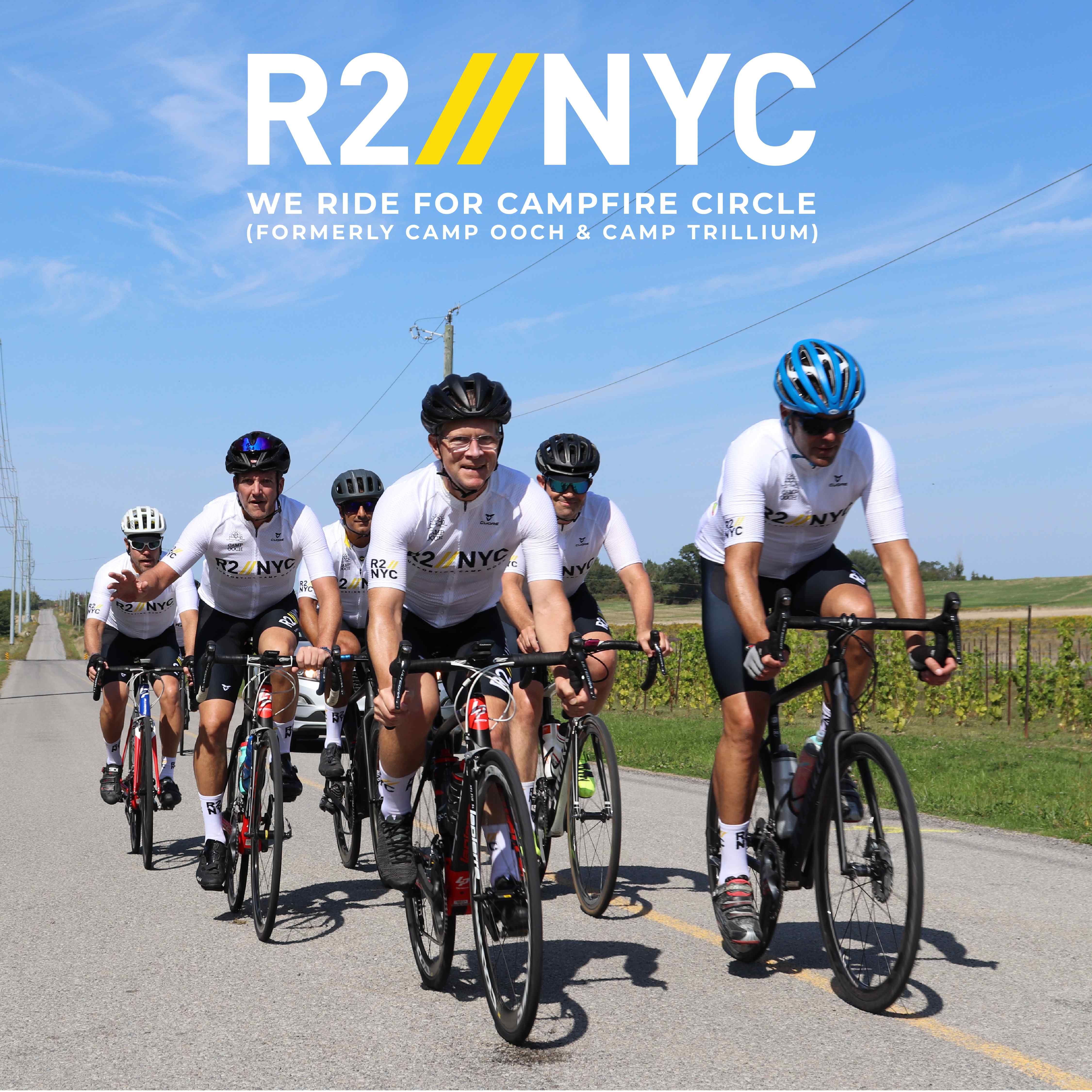 R2NYC We ride for Campfire Circle (Formerly Camp Ooch & Camp Trillium) Six riders biking on road surrounded by blue sky
