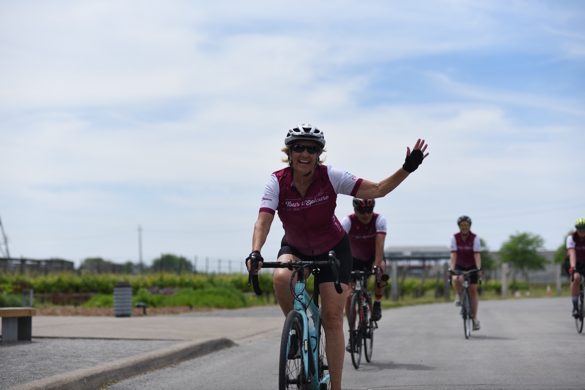 rider waving at camera with riders in the background