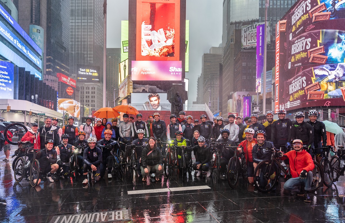 group of cyclists in Times Square posing for a group picture