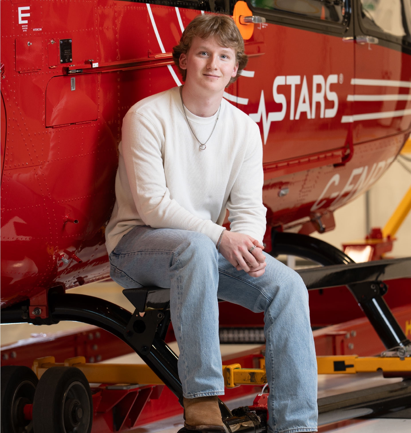 Portrait of STARS Very Important Patient Thomas in front of a STARS H145 Helicopter