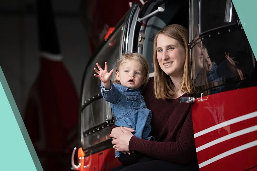 Portrait of STARS Very Important Patient Christine Aarsby and her daughter Addie as they sit in the side door of a STARS H145