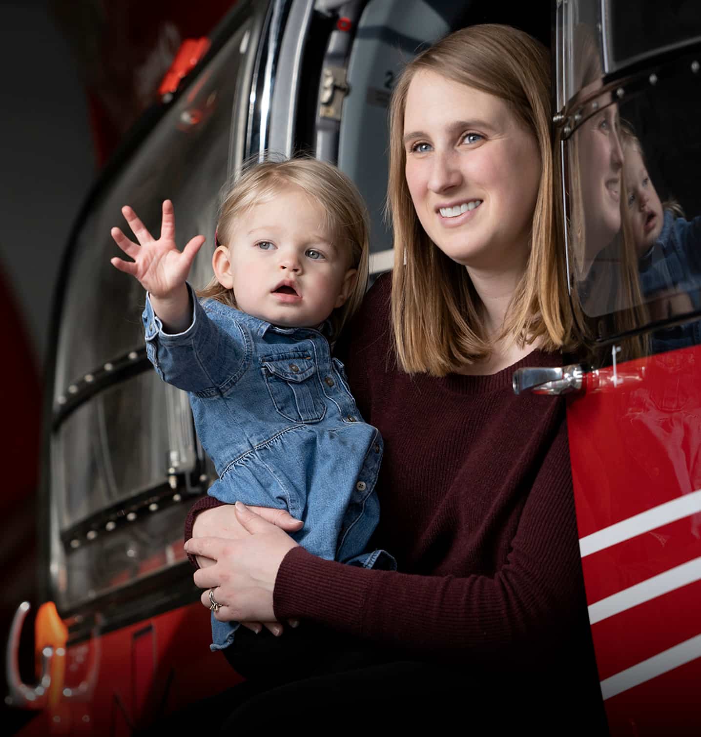 Portrait of STARS Very Important Patient Christine Aarsby and her daughter Addie as they sit in the side door of a STARS H145