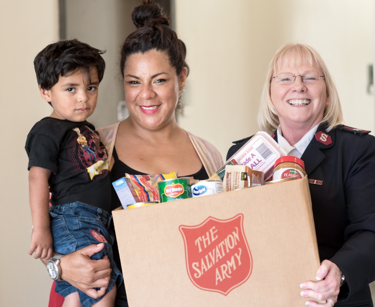 The salvation army officer handing over food hamper