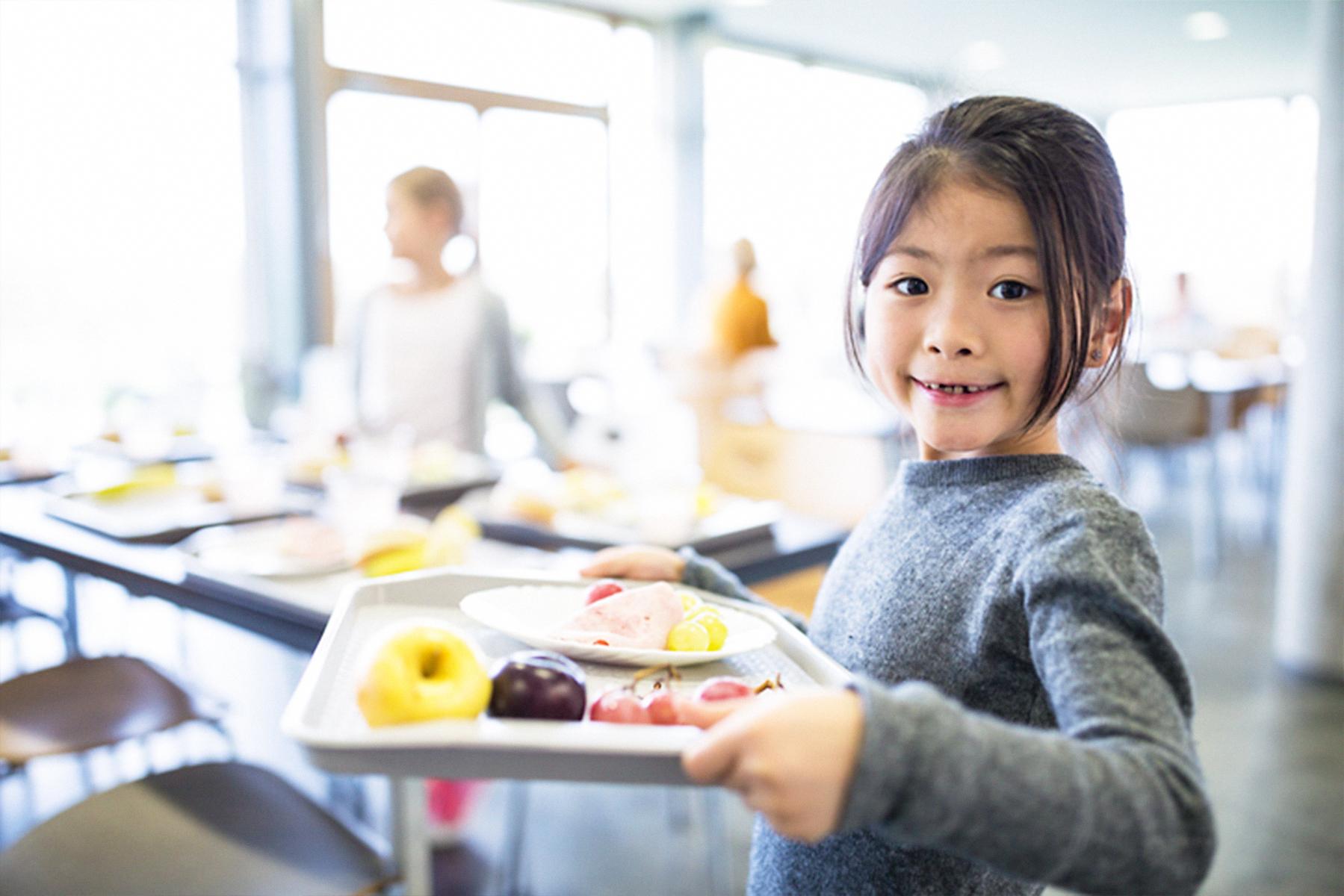 kid at school with tray of food