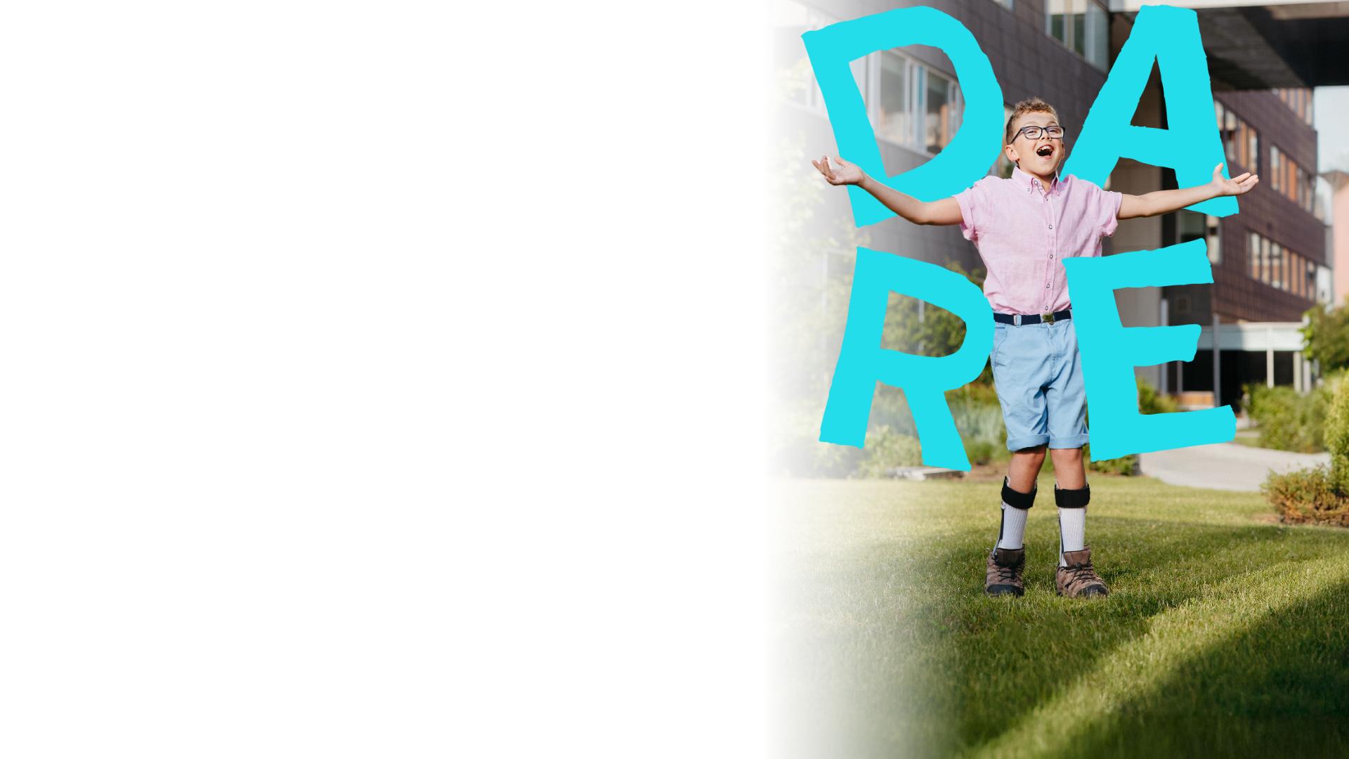 Holland Bloorview Ambassador Alex is standing with his arms spread with the word DARE around him
