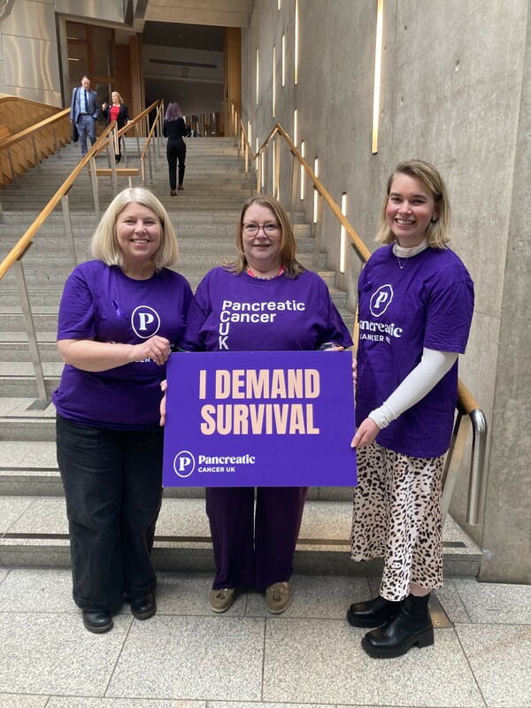 Pancreatic Cancer UK staff and a supportive MSP at Holyrood