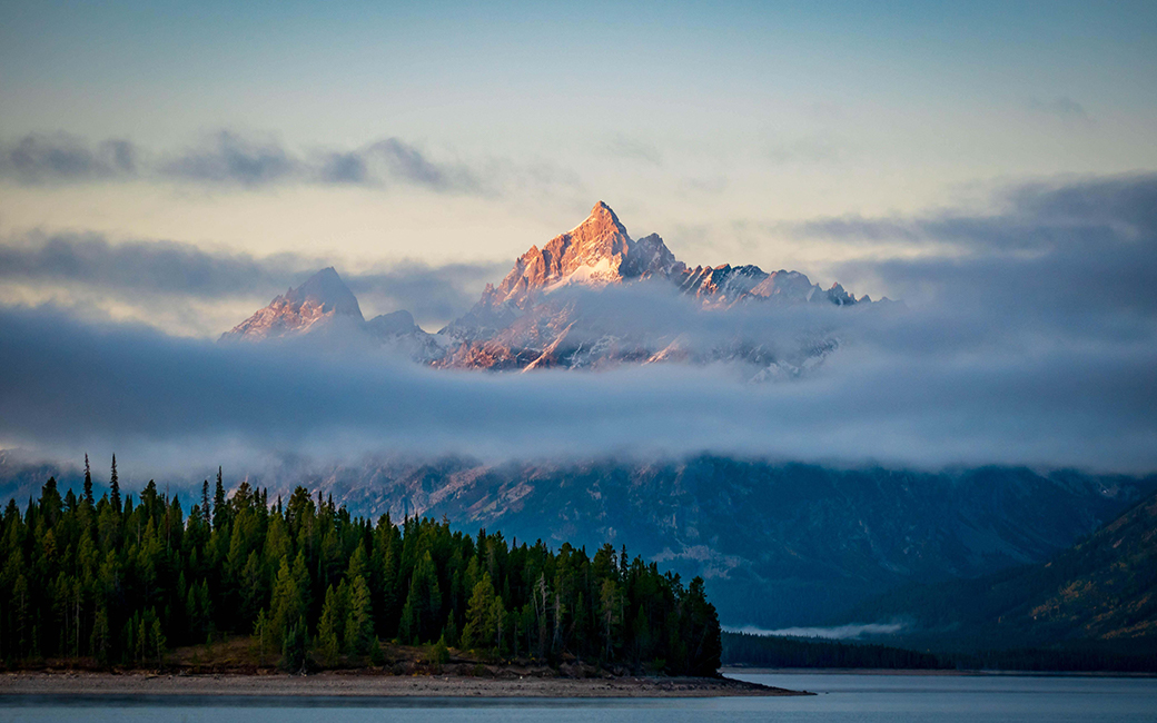 An early morning shot from the shore of Jenny Lake looking up on the Cathedral Group, Wyoming.