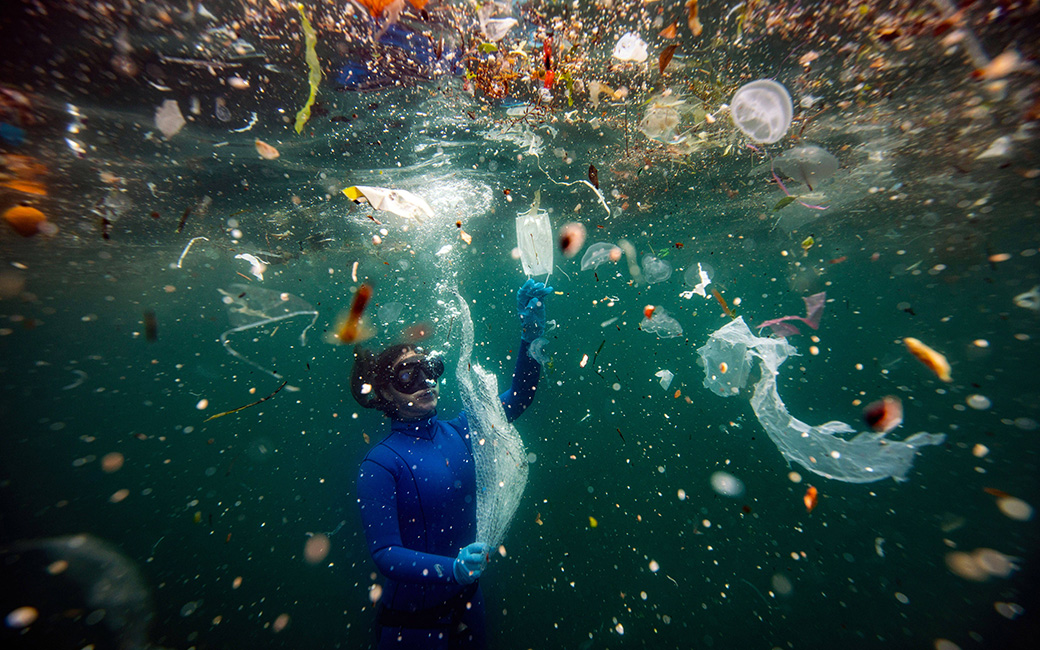 A scuba diver surrounded by plastic waste in the Mediterranean.