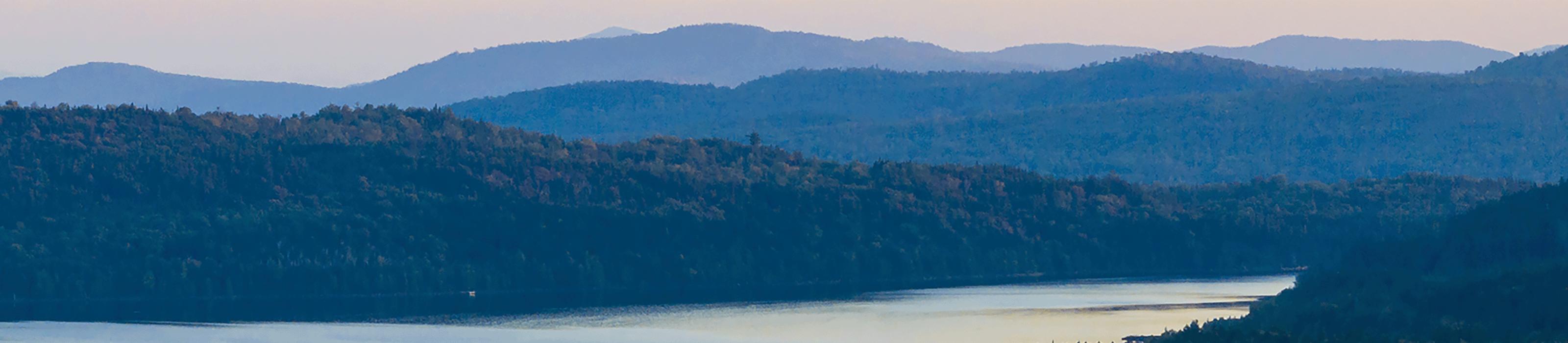 Scenic sunrise view of mountains in the distance and the Magalloway River in the foreground. © Jerry Monkman/EcoPhotography