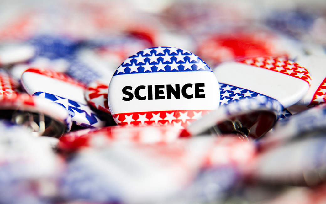 A pile of red, white and blue buttons with the word science written on them.