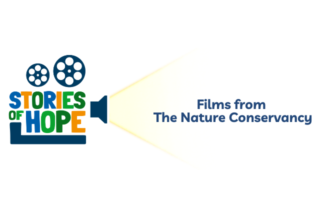 A movie projector projecting the event name: Stories of Hope: Films from The Nature Conservancy. Image Credit © TNC. 
