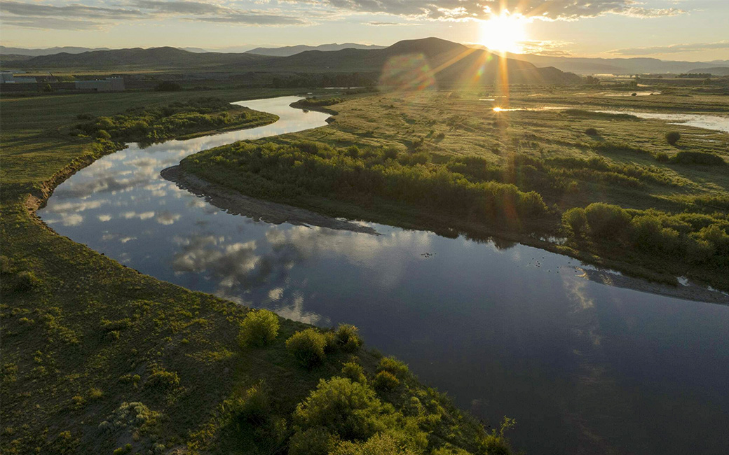 The sun rises over the Colorado River in Kremmling, Colorado on July 9, 2024. © Rory Doyle