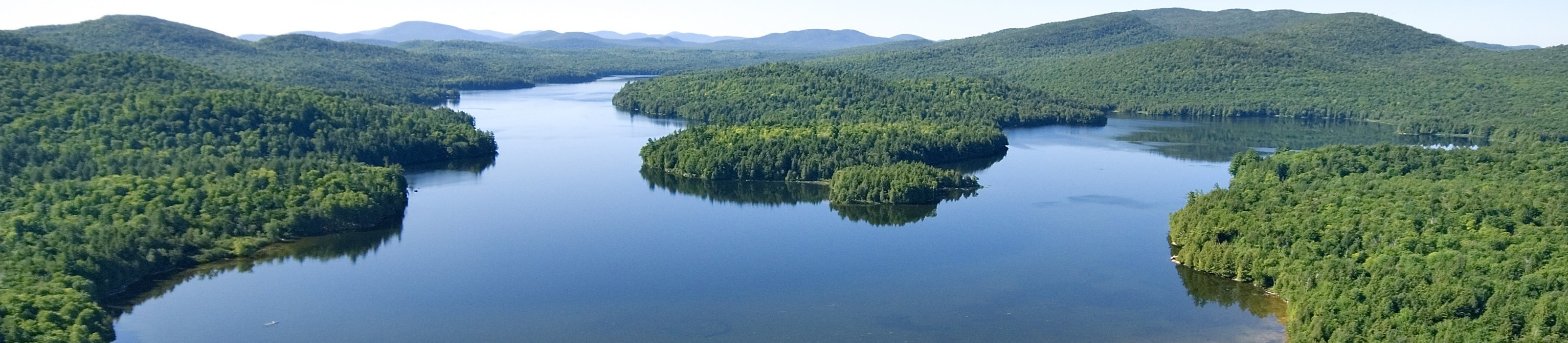 Aerial image of the 970-acre Follensby Pond surrounded by forests and wetlands. © Carl Heilman II