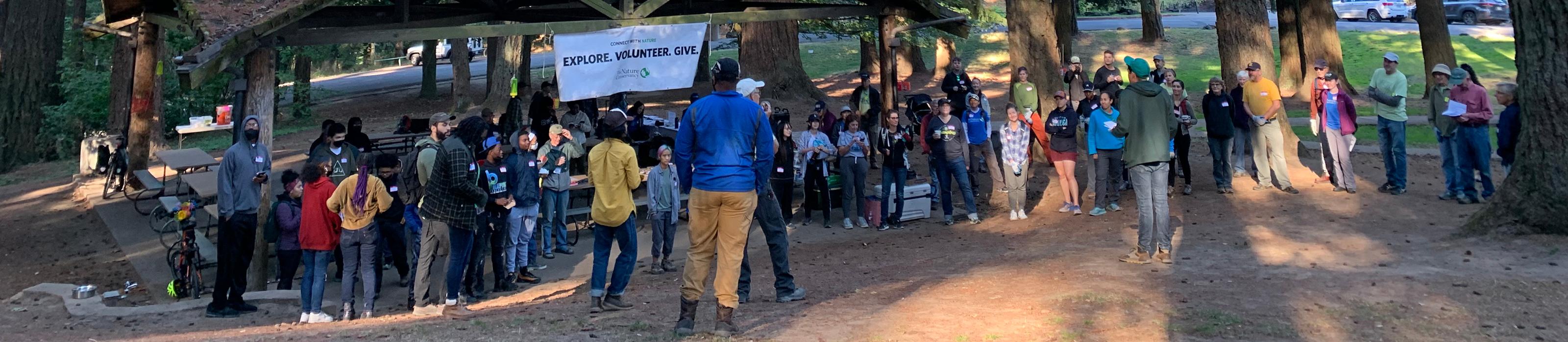 Several people gather in a forested area as part of a Mt. Tabor Park Volunteer Event. © Molly Dougherty/TNC