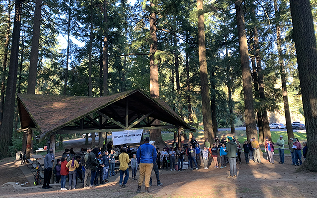 Several people gather in a forested area as part of a Mt. Tabor Park Volunteer Event. © Molly Dougherty/TNC