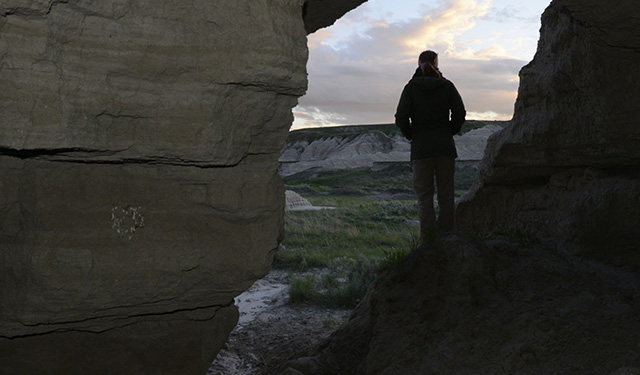 A person exploring the Conata Basin in South Dakota. &copy; Michael Forsberg