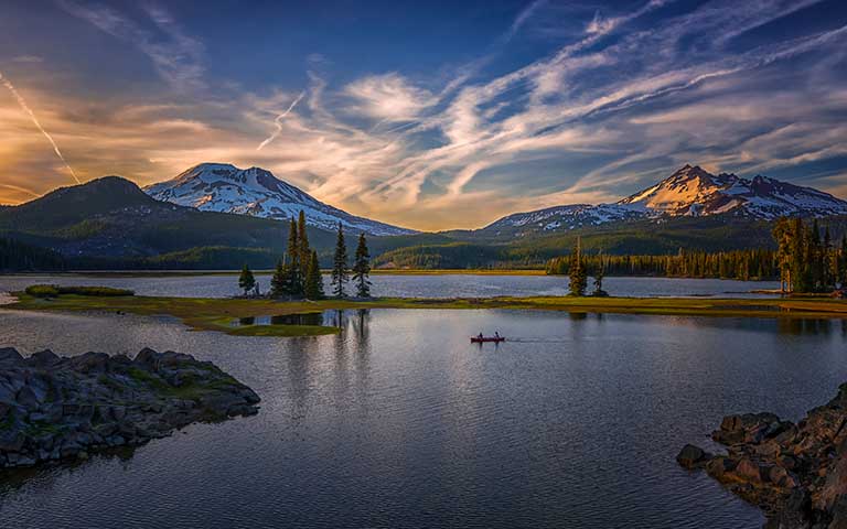 Evening paddlers on Sparks Lake, along the Cascade Lakes Scenic Byway near Bend, Oregon. &copy; Paul Carew