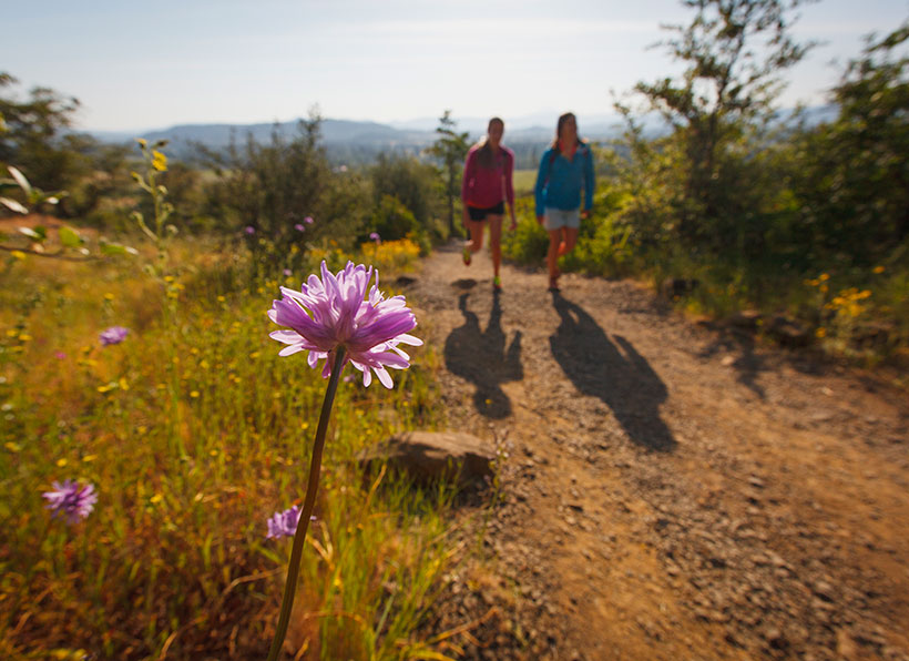 Two women hike past purplehead along the Upper Table Rock trail, Oregon. &copy; Ben Herndon/Tandem Stills+Motion