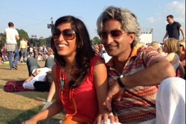 A couple sits together at a music festival