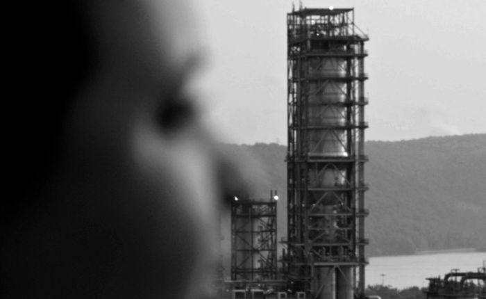 woman looking at petrochemical plant in pennsylvania