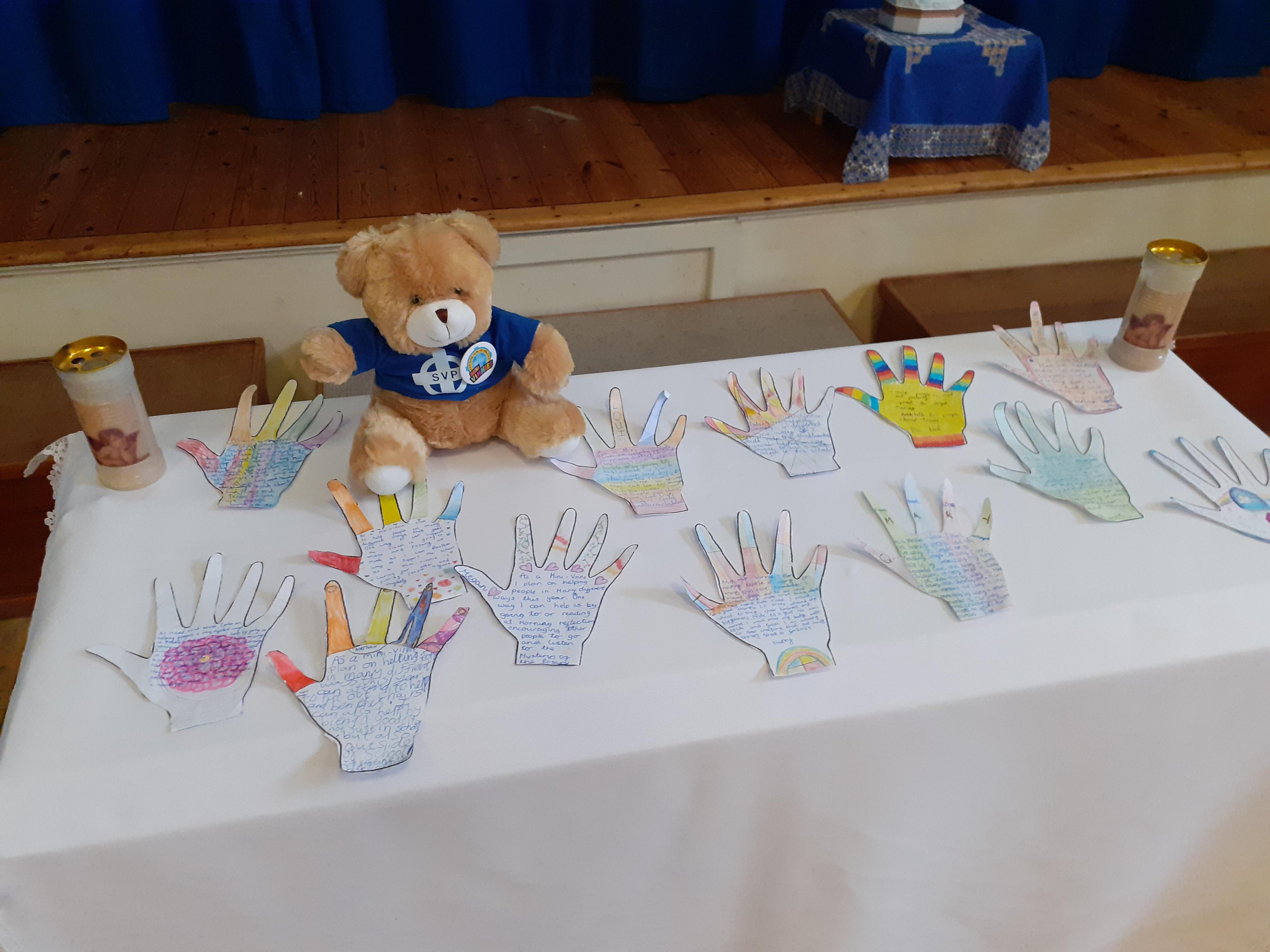 This is a photo of the prayer table with the handprints and Vinnie Bear on.