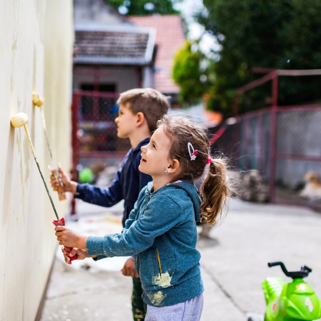 This is an image of children painting a wall.