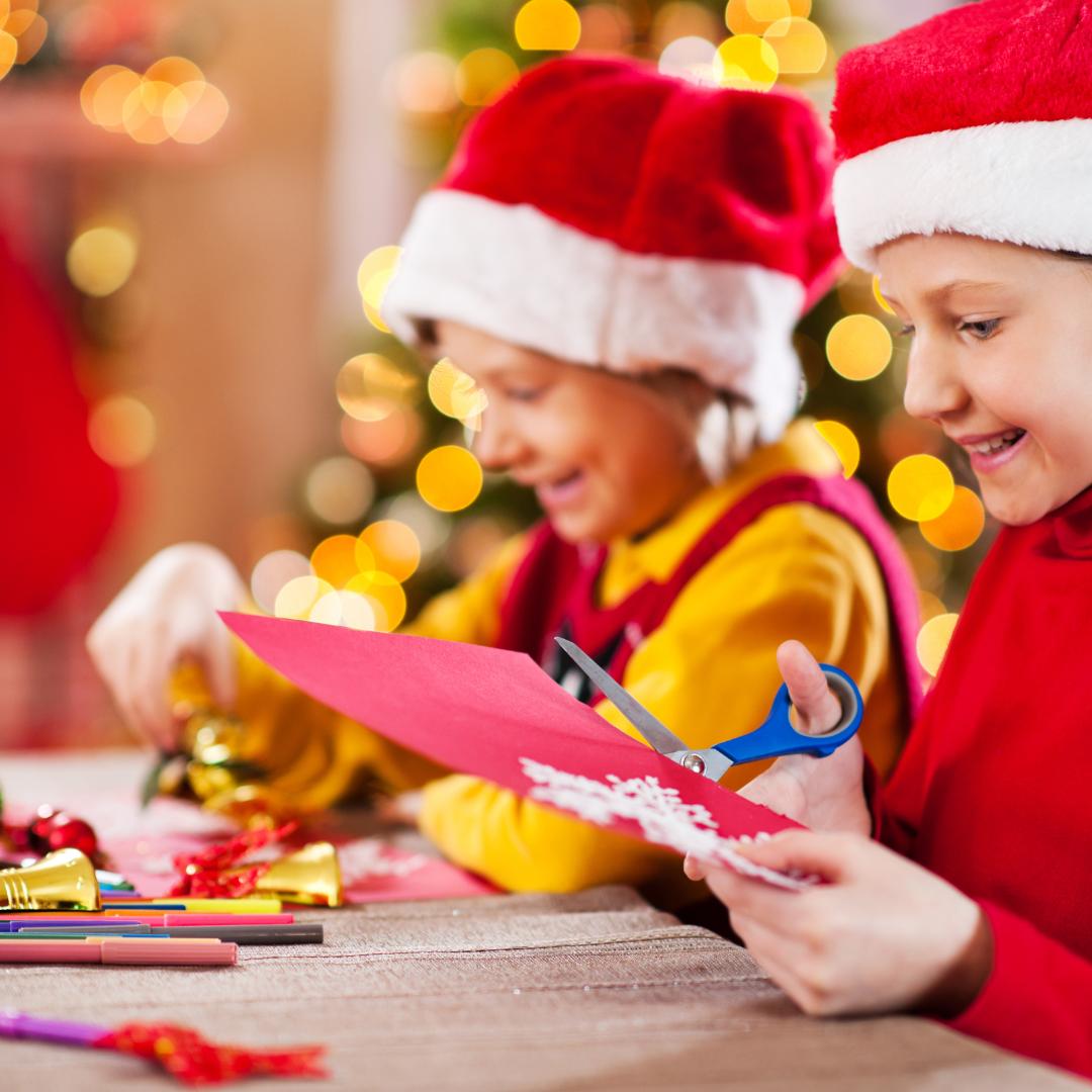 This is a photo of two children making Christmas cards