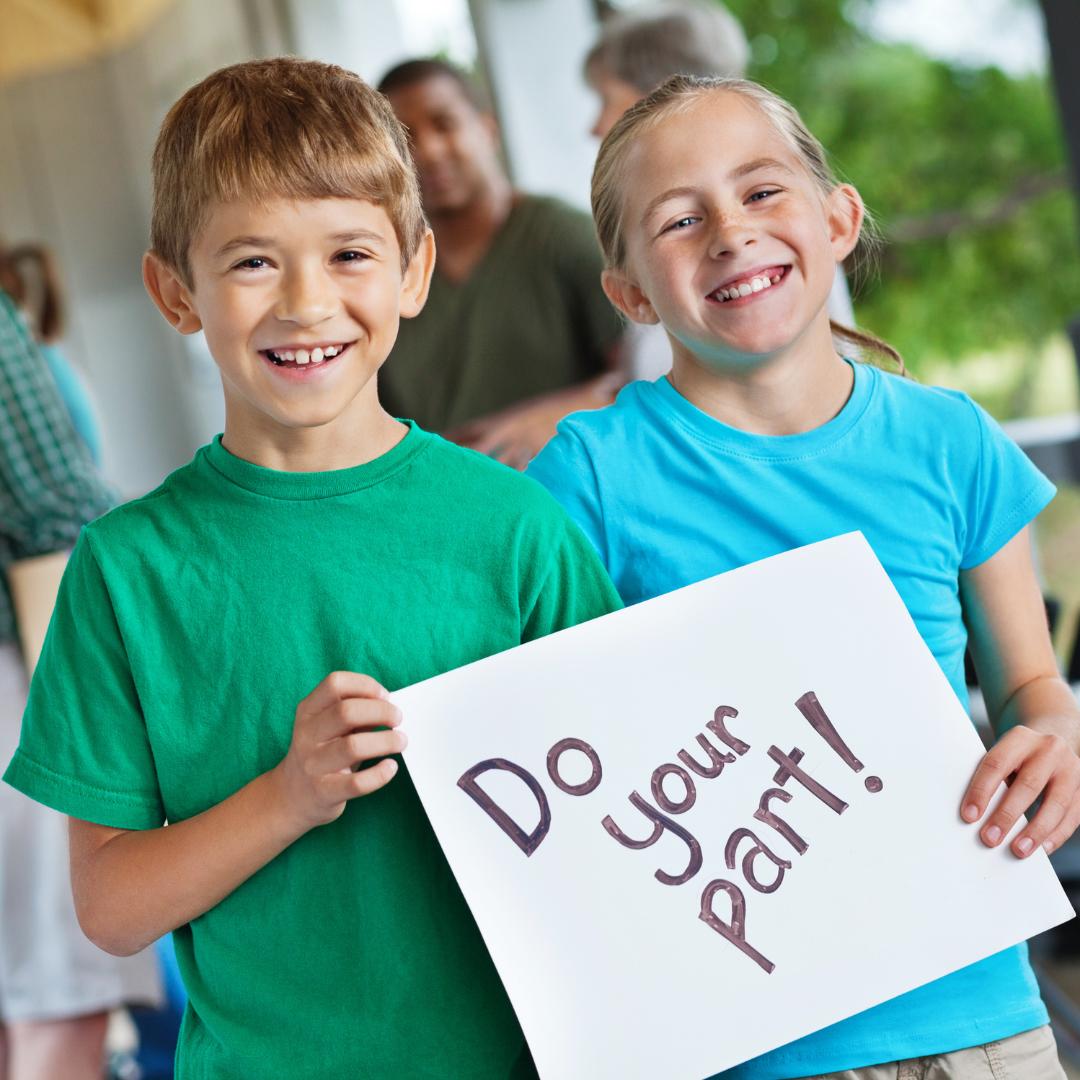 This is a photo of two children holding a sign which reads 'Do your part!'