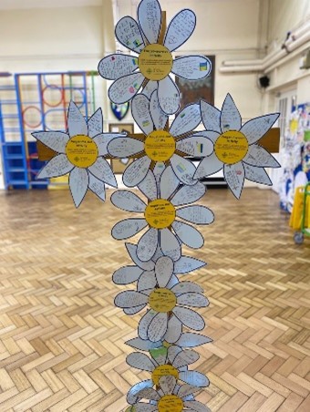 This is a photo of a cross made of forget-me-not flowers